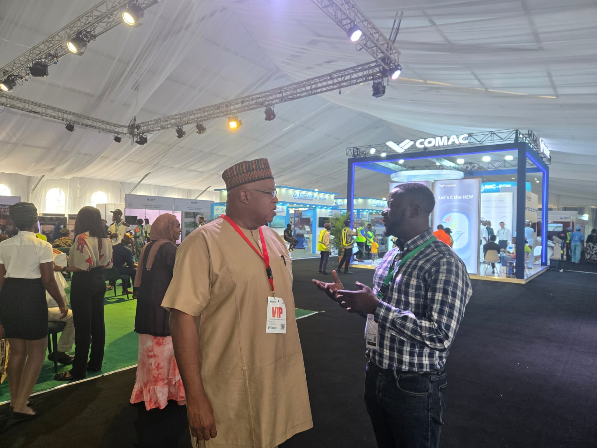 Two delegates speaking on an exhibition floor